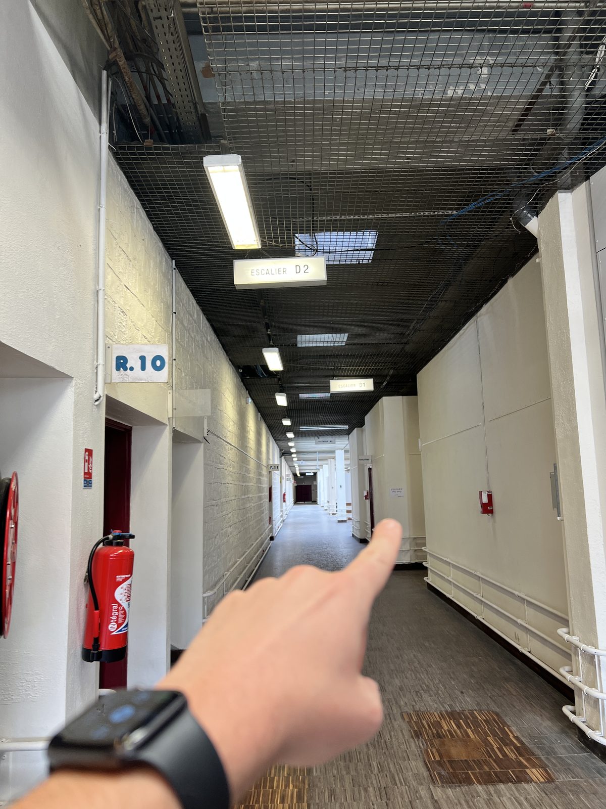 Couloir intérieur du R9, direction la porte rouge